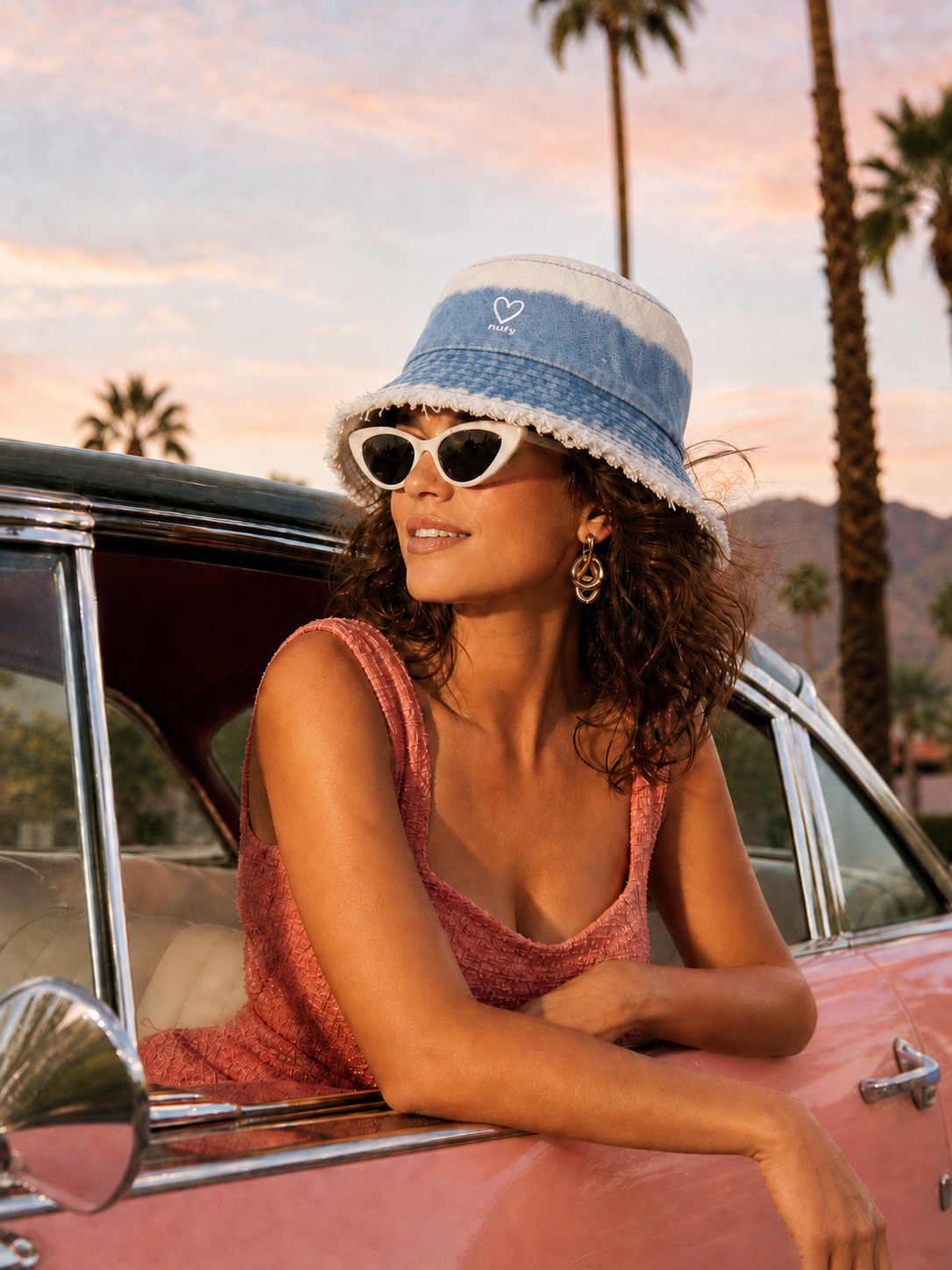 Model wearing tie dye blue denim frayed edge bucket hat